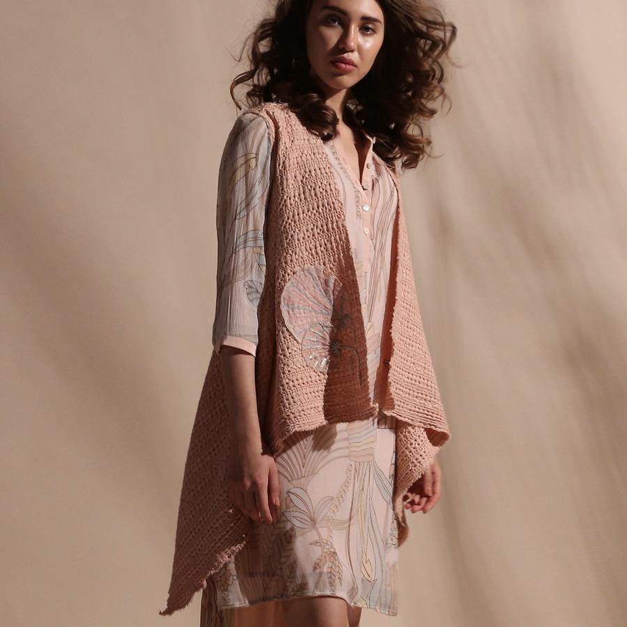 Cotton dobby draped elegant pattern sleeveless jacket embellished with fine thread and sequin 3D placement embroidery. The jacket has unique asymmetrical cut that is versatile in nature. It can be teamed up with diverse separates. abhisheksharma, abhishekstudio