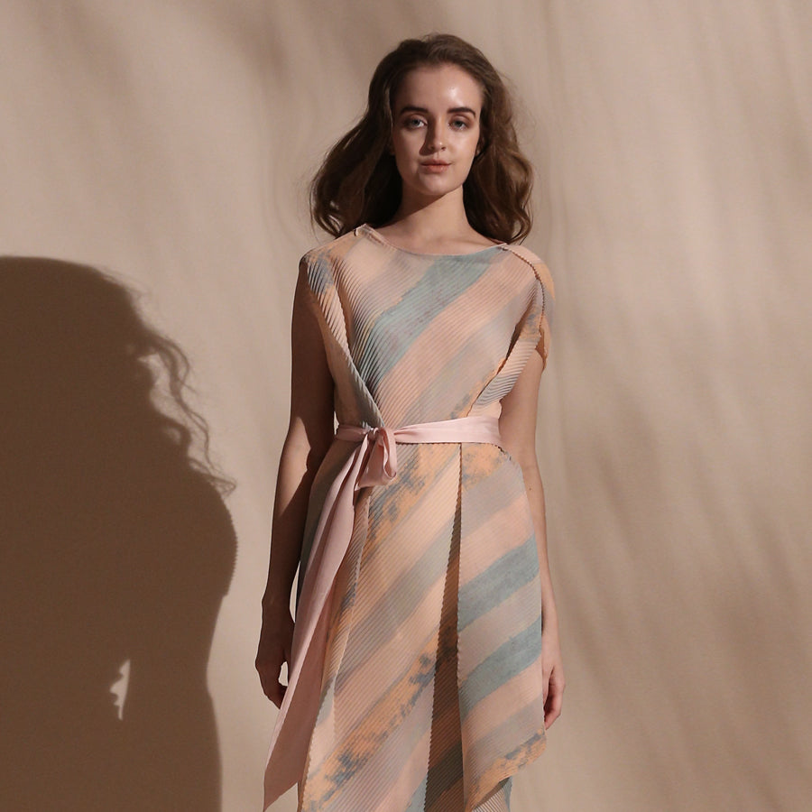 Stripe batik print fine pleated texture draped dress with satin tie up belt. Its a sleeveless look with a crepe inner. The dress is draped in bias and the print appears visually as an interesting mix of bias and vertical stripes. abhishek sharma, abhishekstudio