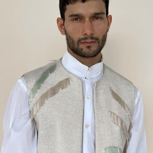 Open front handloom khadi bundi with round neckline. Cotton khadi texture bundi is embellished with abstract palm leaf pattern embroidery in hand sewn bugle beads.  abhisheksharma , abhishekstudio