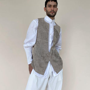 Handloom khadi bundi with single botton closure and shaped back. Cotton khadi shot texture bundi is ornamented with abstract distress print.  abhishek sharma, abhishekstudio