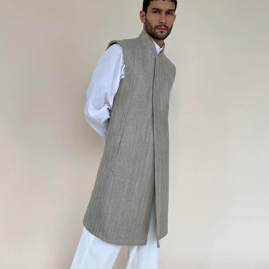 Shaped mandarin collar sherwani with front overlap closure. Heavy weight woven texture linen sherwani features square armhole and slightly layered panels for that extra ease while sitting and or on the go.  abhisheksharma , abhishekstudio