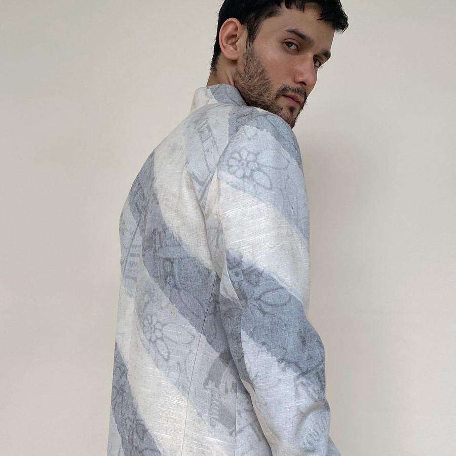 Short length single button closure sherwani with concealed placket. Cotton khadi sherwani is meticulously printed in abstract bias stripes.  abhisheksharma , abhishekstudio