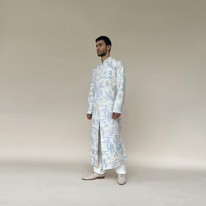 Classic mandarin collar sherwani with a buttoned closure. Heavyweight Matka silk sherwani features high slits and slightly flared panels for that extra ease while sitting or on the go. Sherwani is embellished in abstract impression pattern with multicolour silk thread.  Abhishek Sharma, abhishekstudio