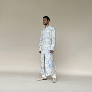 Classic mandarin collar sherwani with a buttoned closure. Heavyweight Matka silk sherwani features high slits and slightly flared panels for that extra ease while sitting or on the go. Sherwani is embellished in abstract impression pattern with multicolour silk thread.  Abhishek Sharma, abhishekstudio