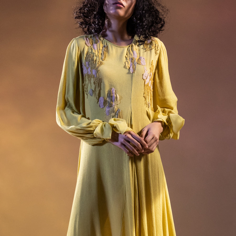 Textured crepe panelled draped long tunic with tie-up sleeve detailing. The tunic has fine Resham placement embroidery.   Styling: the tunic can be worn as a dress as shot on the model. The tunic can also be teamed up-fitted pants. The look is a perfect day and evening. You can stylise the look with big pearl springs or you can keep it simple and carry a statement clutch. Keep the heels very simple so that the complete look doesn’t get busy and stays chick. Abhishekstudio Abhishek Sharma