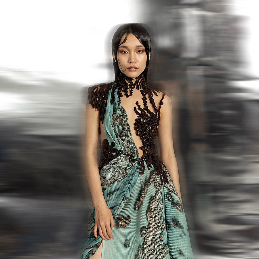 upperbody view of Women's reef printed couture gown with asymmetrical drape and dark embroidered bodice – statement cocktail or red carpet look