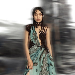 upperbody view of Women's reef printed couture gown with asymmetrical drape and dark embroidered bodice – statement cocktail or red carpet look