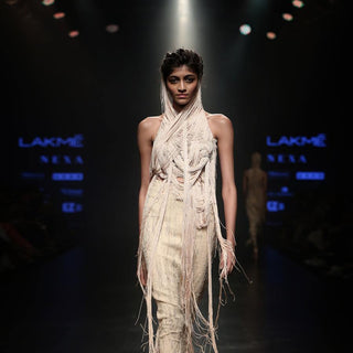 front shot of Women's ivory halter yarn top with layered drapes and textured pencil skirt for couture runway look