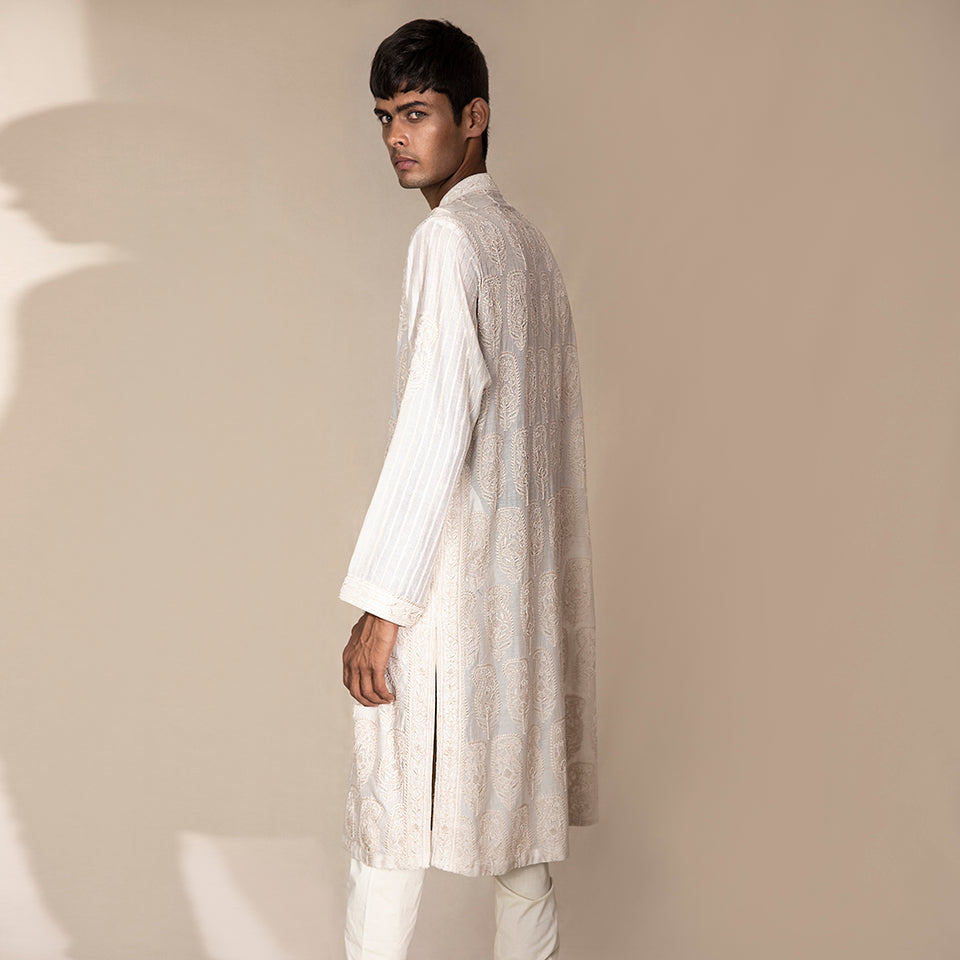 profile view of Men's ivory Chikankari kurta with rear paisley embroidery and striped sleeves – artisanal ethnic festivewear