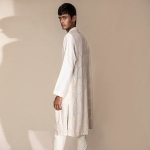 profile view of Men's ivory Chikankari kurta with rear paisley embroidery and striped sleeves – artisanal ethnic festivewear
