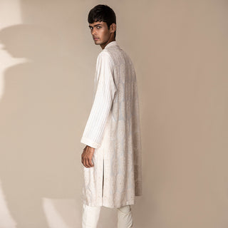 profile view of Men's ivory Chikankari kurta with rear paisley embroidery and striped sleeves – artisanal ethnic festivewear