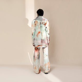 Back view of men's abstract crystalline print shawl collar suit with flared trousers and draped scarf – couture runway menswear ensemble