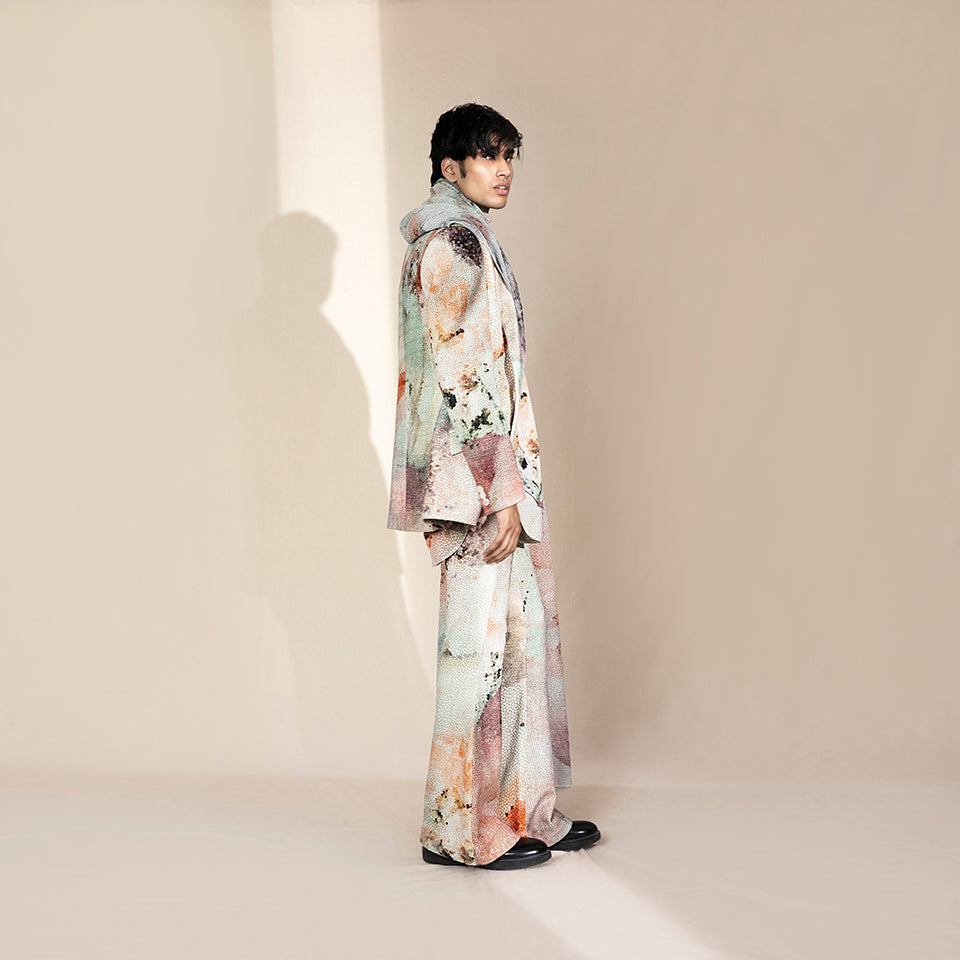 Men's side view in abstract crystalline print jacket with matching relaxed trousers – artistic menswear set, luxury fashion-forward silhouette