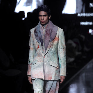 runway front view of men's abstract crystal-print shawl collar suit with layered scarf – Lakmé runway couture look in luxe pastel textured fabric