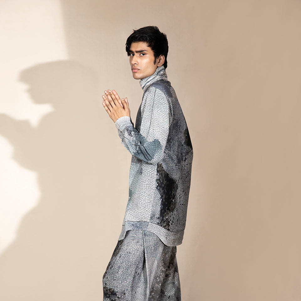 side shot of Men's crystalline printed high-neck shirt with curved hem and relaxed sleeves – contemporary fashion-forward silhouette