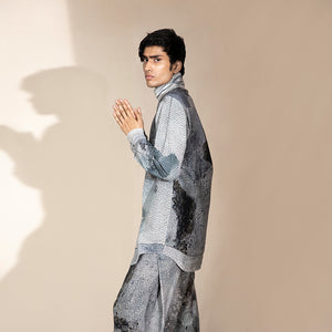side shot of Men's crystalline printed high-neck shirt with curved hem and relaxed sleeves – contemporary fashion-forward silhouette