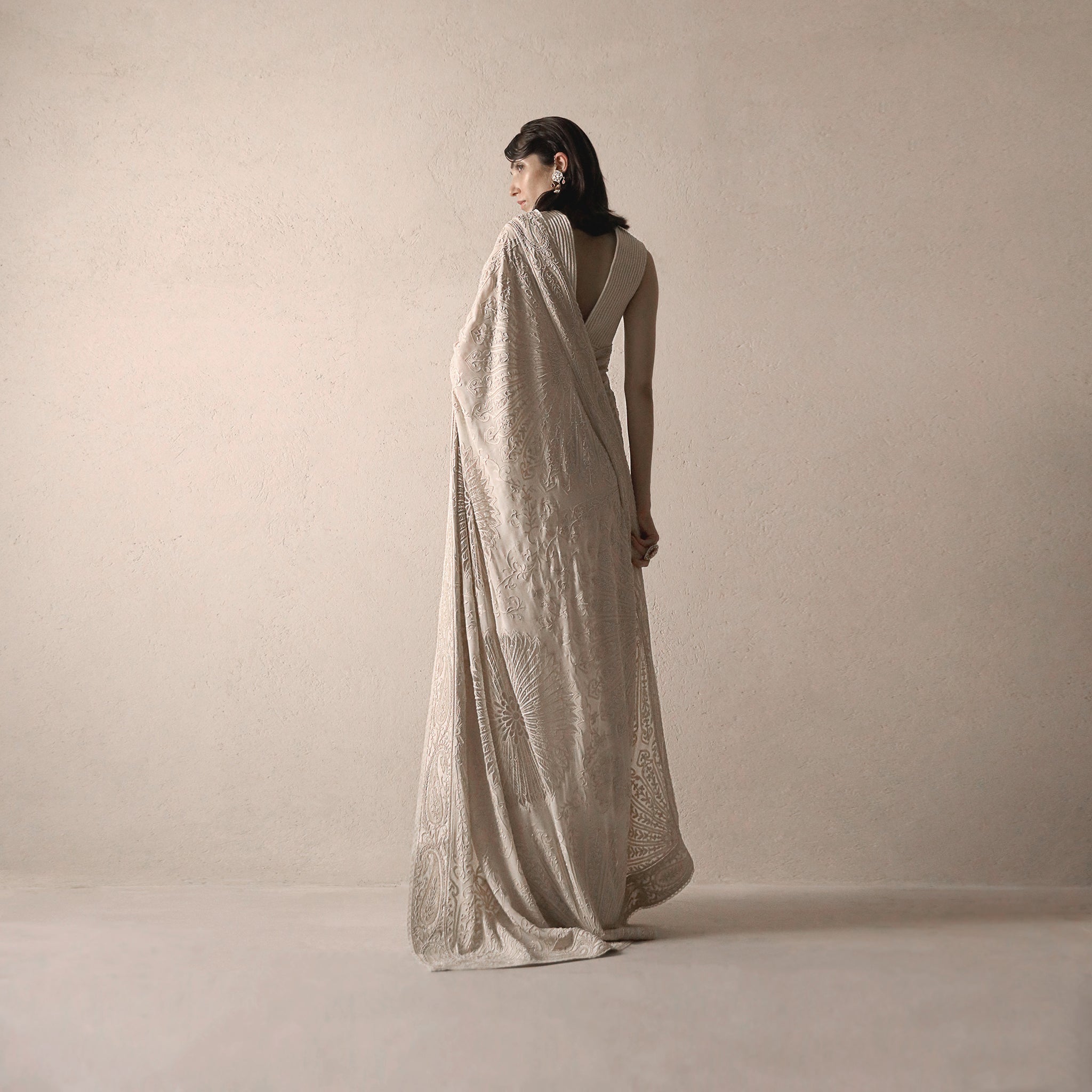 back view of Women's heritage-inspired chikankari saree with fine hand embroidery and deep back blouse – timeless draped couture for formal events