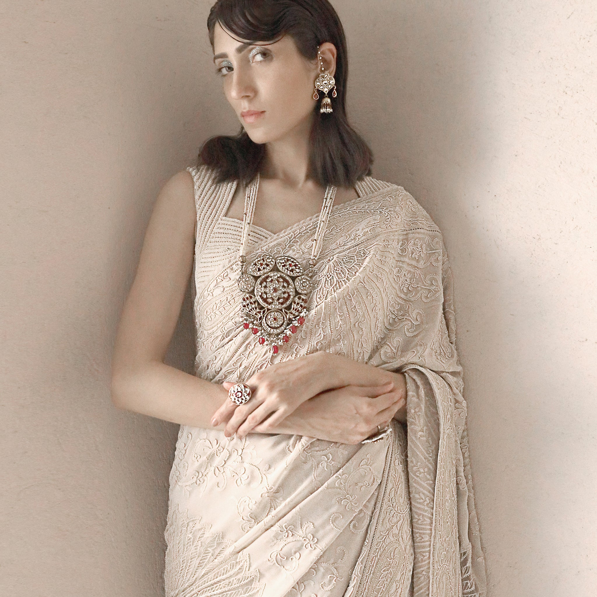 close-up of Women's pre-pleated chikankari saree with fine hand embroidery and statement temple jewellery – timeless bridal couture elegance