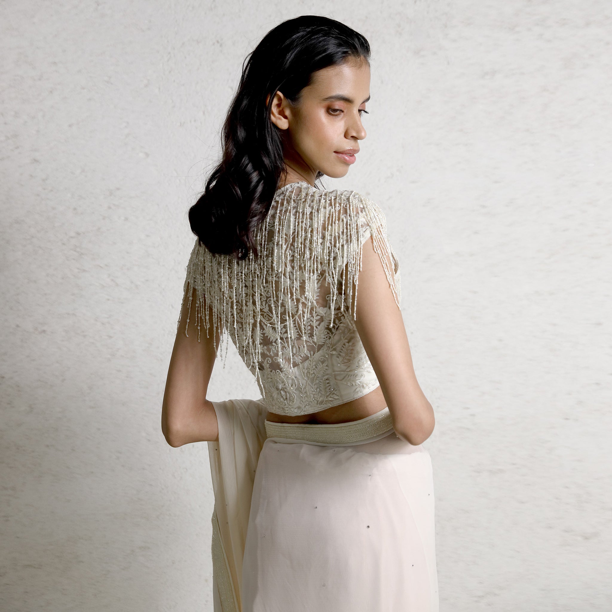 upperback view of Women's pre-draped saree with beaded tassel blouse and sheer back – bold modern elegance for cocktail and evening wear