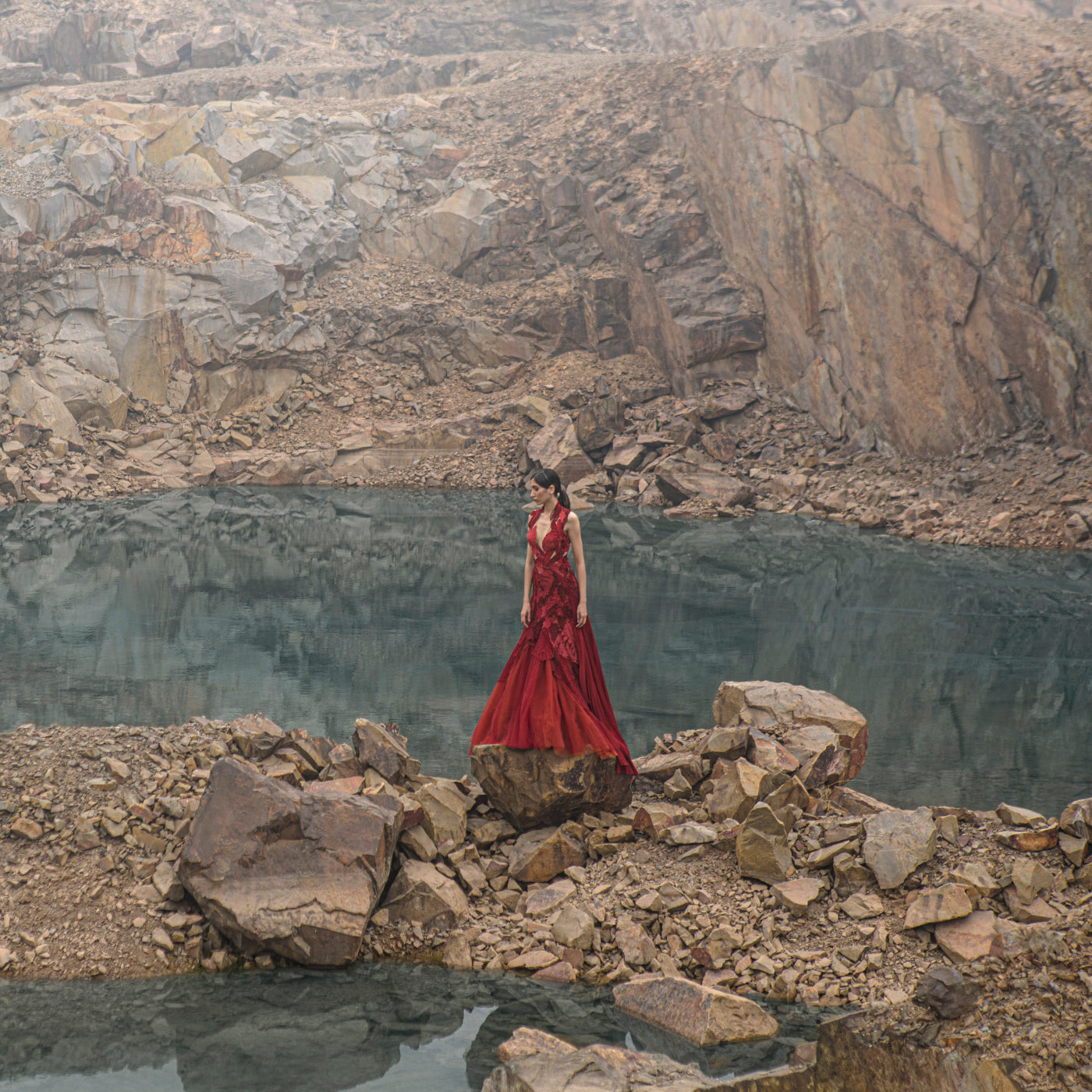 full length of Women's deep red couture gown with textured embroidery and satin flare – statement designer wear for evening receptions