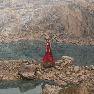 full shot of Women's crimson couture gown with embroidered bodice and flared satin trail – dramatic eveningwear for receptions
