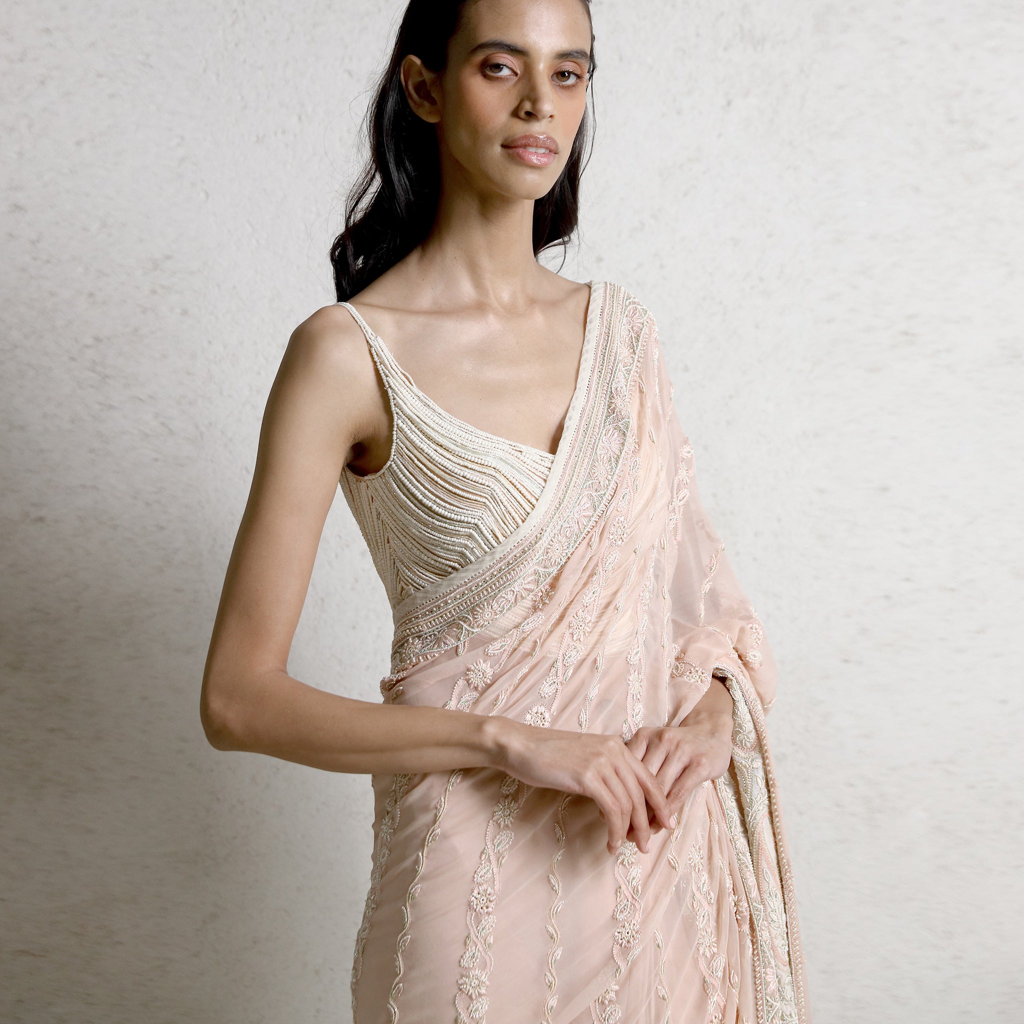 Women's blush pink pre-draped chikankari saree with pearl-embellished blouse and crystal accents – luxury ethnic couture wear