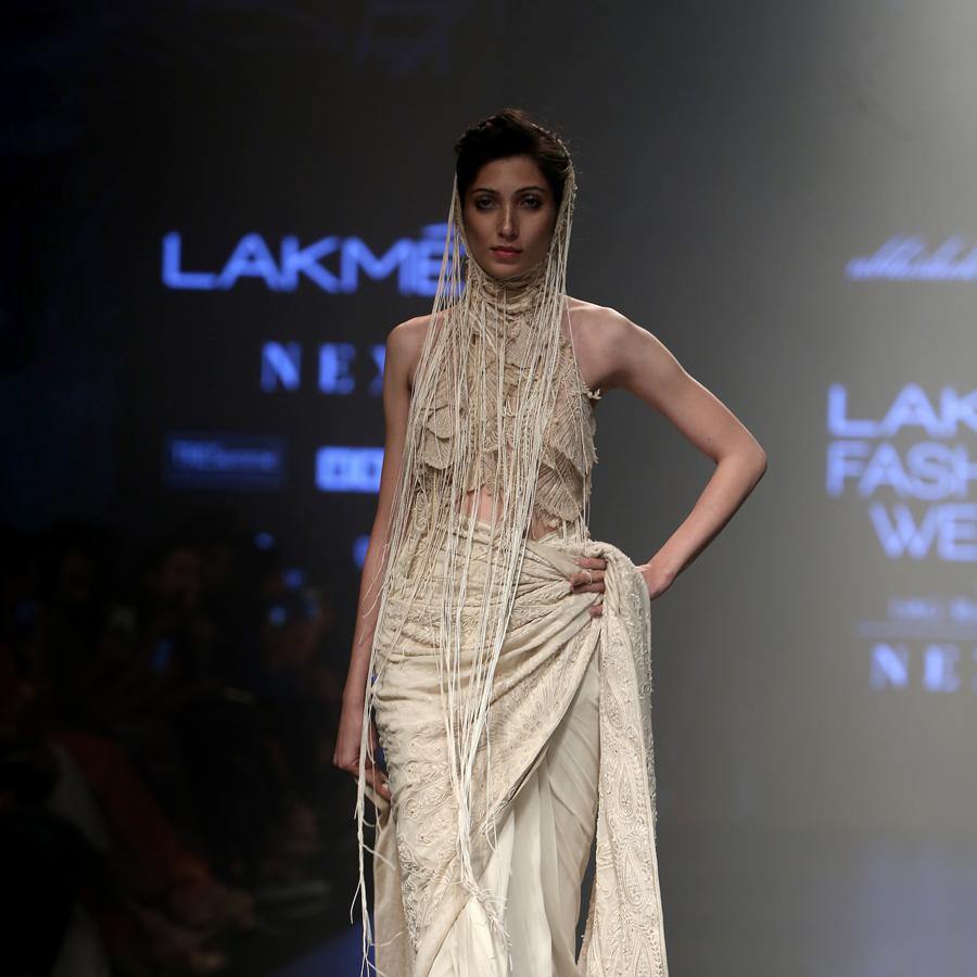 front view of Women's pre-pleated chikankari saree with contemporary embroidered blouse and fringe detailing – bold runway couture for receptions