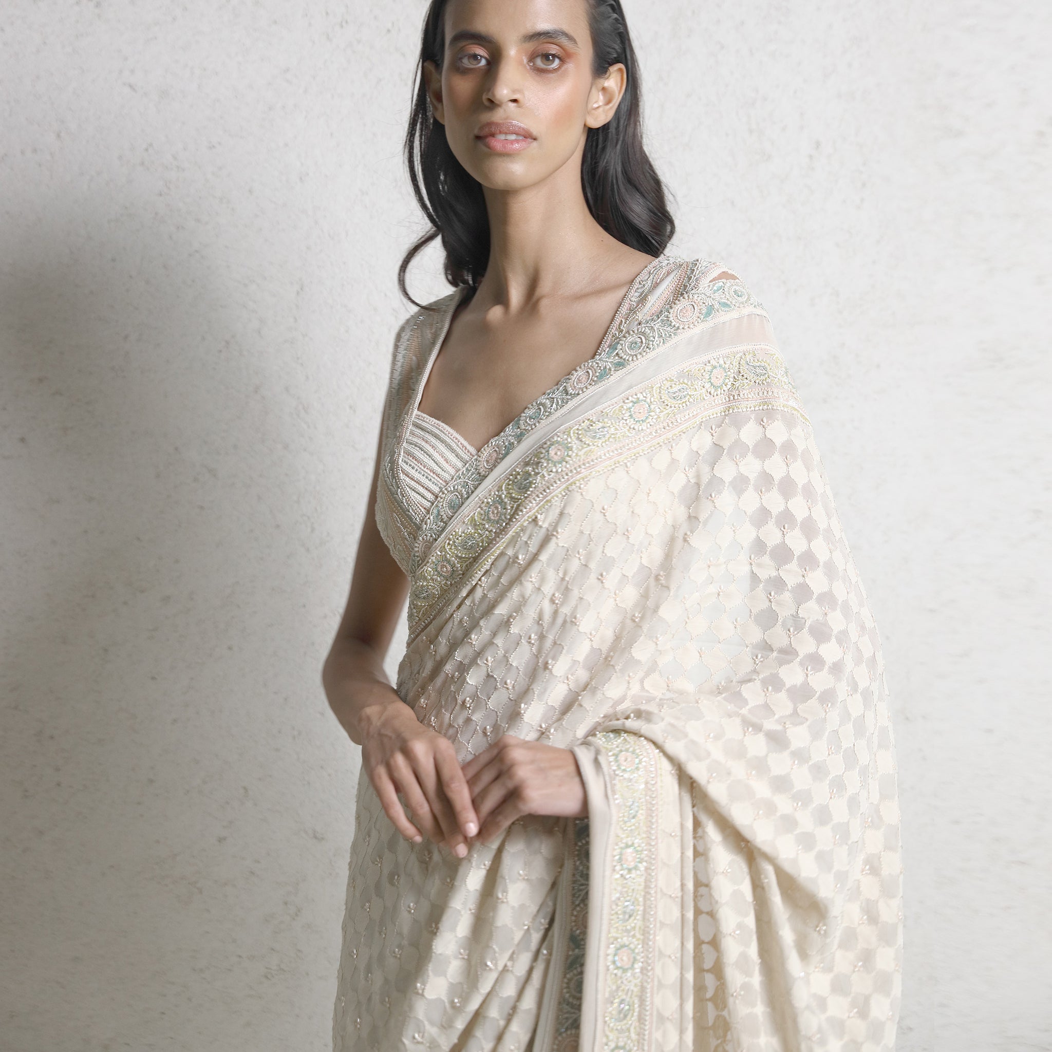 upper body shot of Women's chikankari saree with jharokha shadow work and pastel embroidered border – couture hand-embroidered piece for red carpet events
