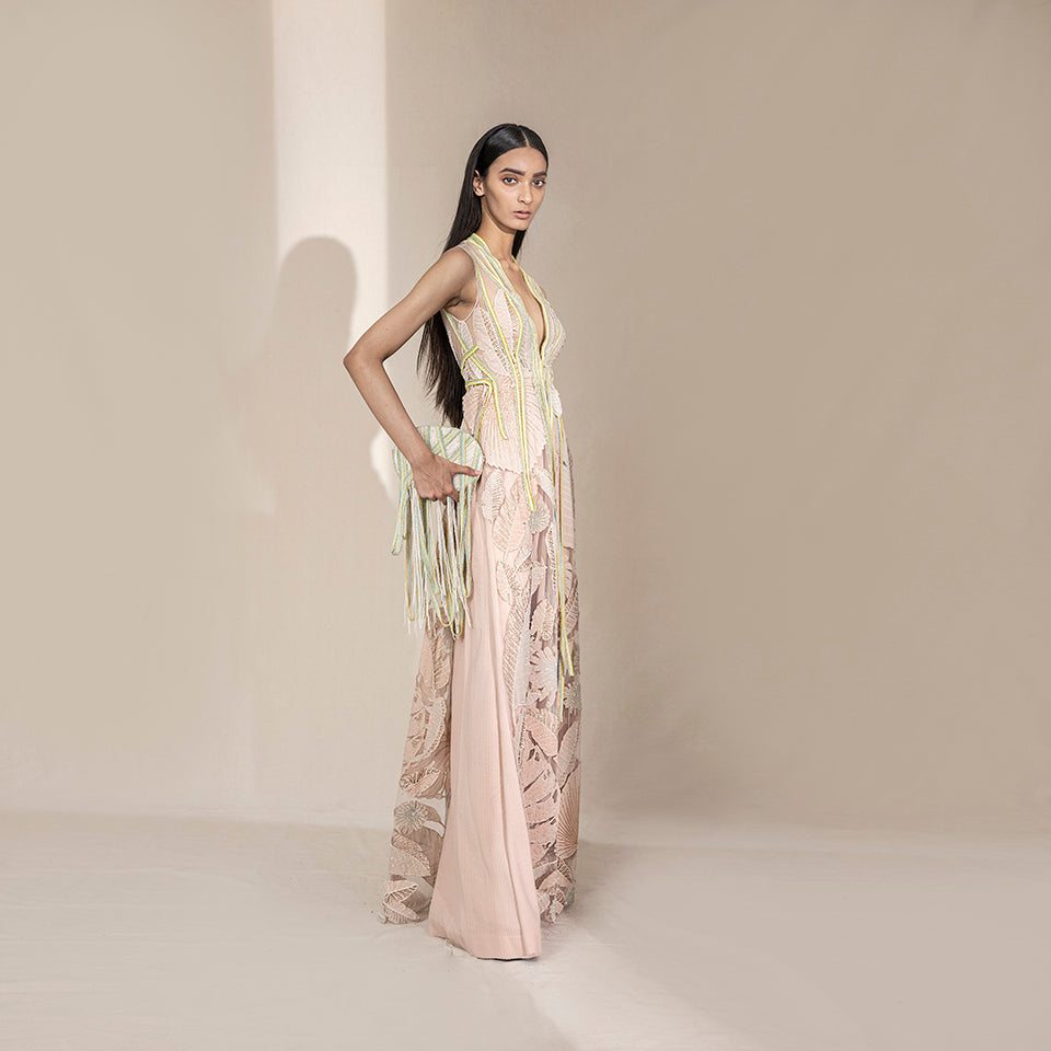 profile shot of Women's blush pink sleeveless embroidered jacket with sheer leaf motifs and neon piping – artistic overlay for stylish party dressing