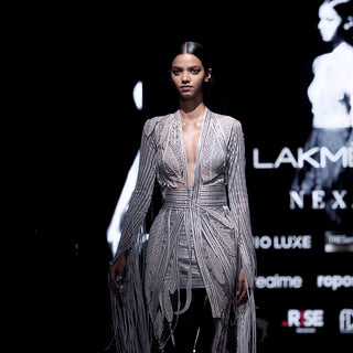 Runway look featuring women's embroidered cocktail jacket with fringe sleeves and leaf motif mini skirt – Lakmé fashion week partywear ensemble