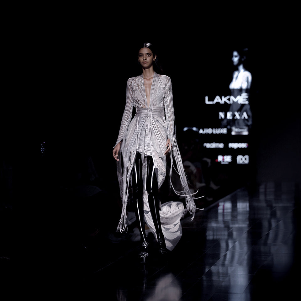 Women's Lakmé runway co-ord set with embroidered longline jacket, fringe sleeves, and leaf motif skirt – dramatic couture partywear look