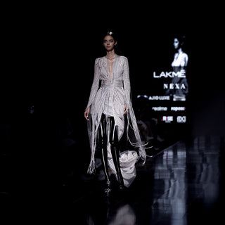 Women's Lakmé runway co-ord set with embroidered longline jacket, fringe sleeves, and leaf motif skirt – dramatic couture partywear look