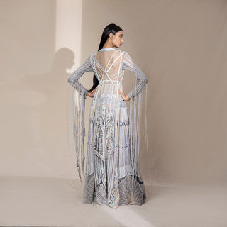 back view of Women's sheer-back silver jacket with pearl tassels and ornate embroidery – high-fashion couture layer with dramatic detailing