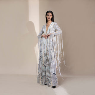 Women's silver floor-length jacket with cascading pearl tassels and fan-inspired embroidery – opulent couture piece for red carpet wear