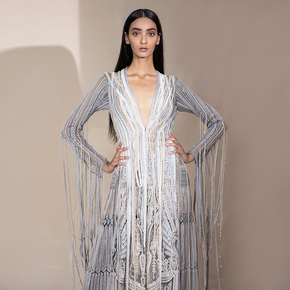 upperbody front view of Women's deep V-neck silver jacket with pearl tassel sleeves and ornate embroidery – luxe couture silhouette for fashion-forward events