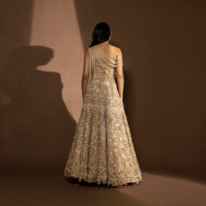 back view of Women's gold bridal lehenga with intricate embroidery and back-draped one-shoulder blouse – designer wedding ensemble, sangeet look
