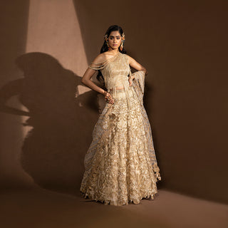 full front view of Women's gold sequin embroidered lehenga with one-shoulder layered blouse and sheer dupatta – luxury bridal co-ord for wedding or sangeet