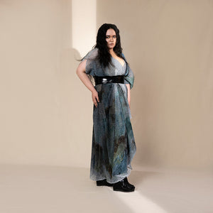 profile shot of Women's layered graphic shimmer dress with flared hem and black obi belt – crystal-textured party gown for youngster evening looks