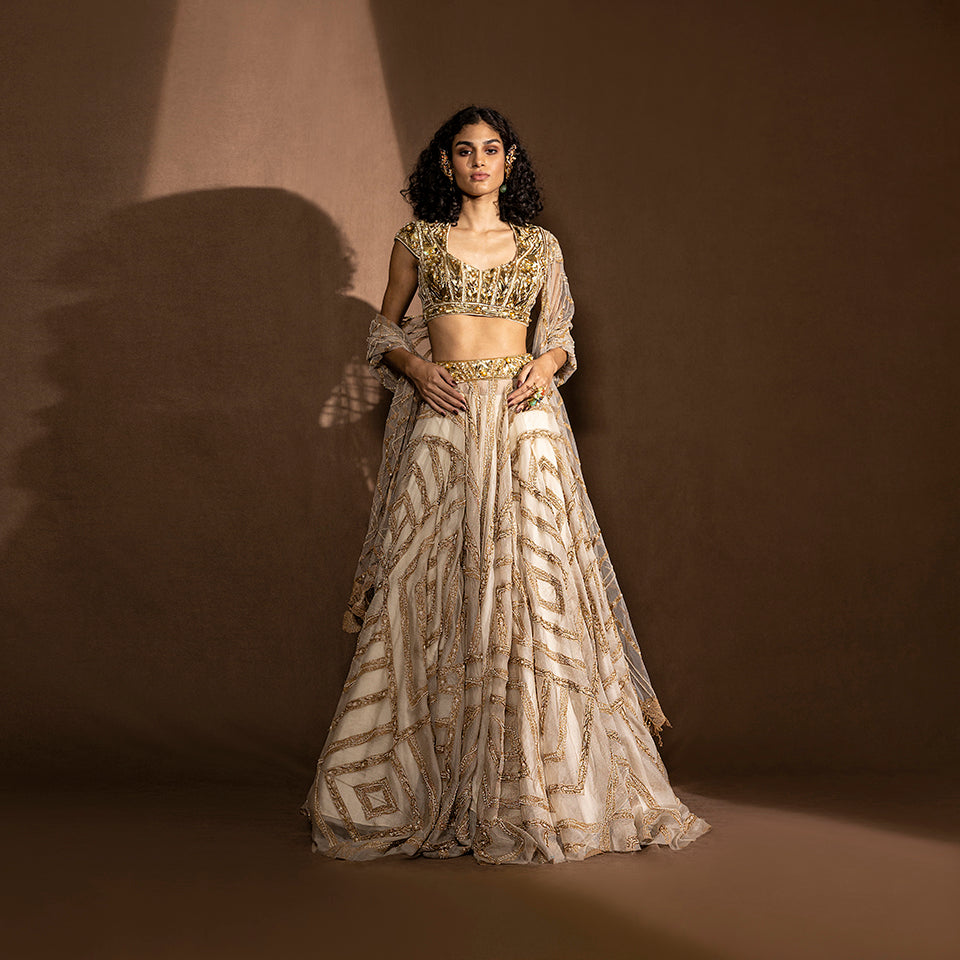 front view of Women's lehenga with geometric gold embroidery and sculptural embellished blouse – bridal couture set, modern designer bride look