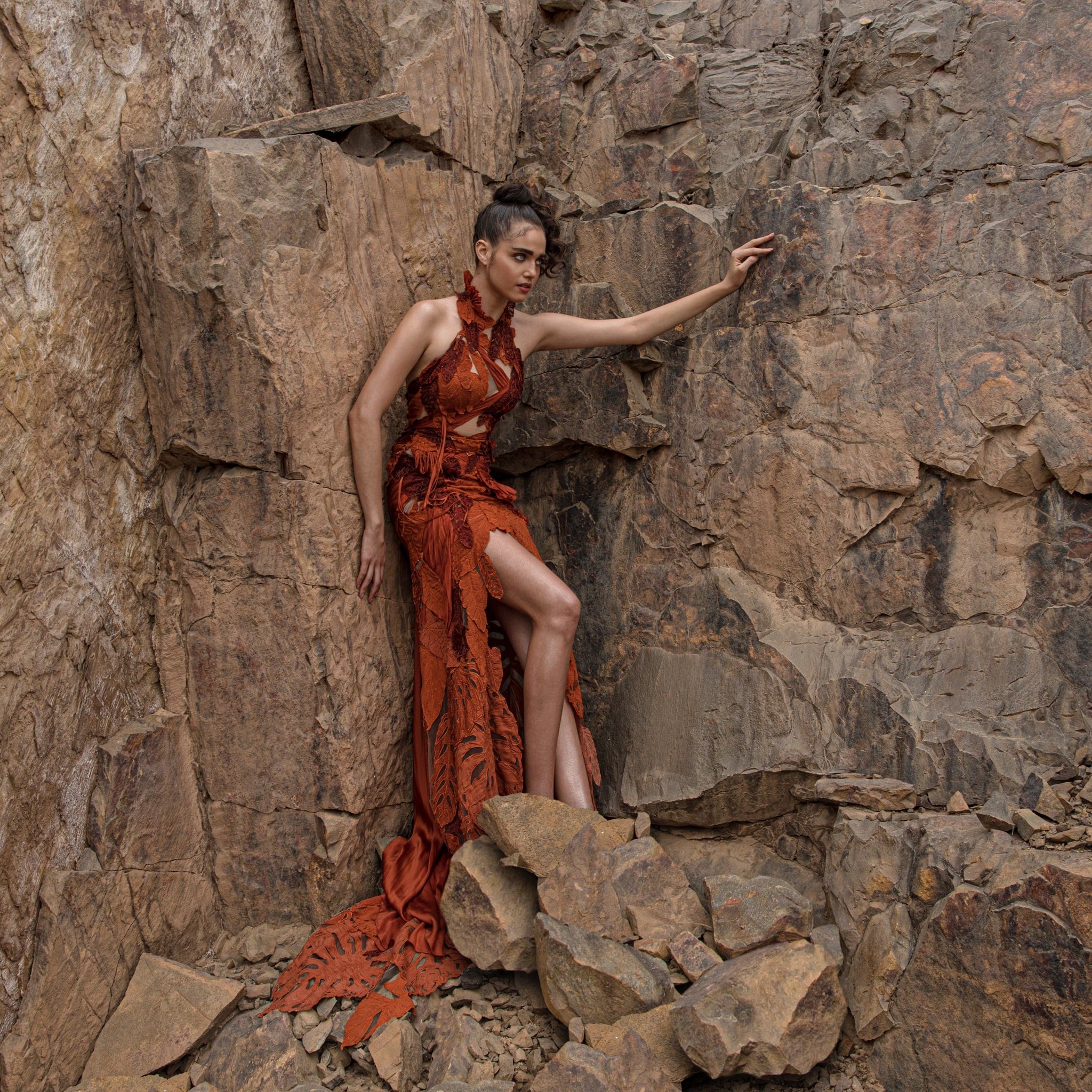wide shot of Women's burnt orange halter gown with high slit and leaf applique trail – youthful statement look for cocktail evenings