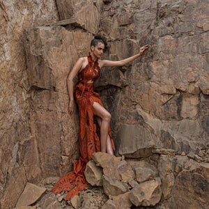 wide shot of Women's burnt orange halter gown with high slit and leaf applique trail – youthful statement look for cocktail evenings