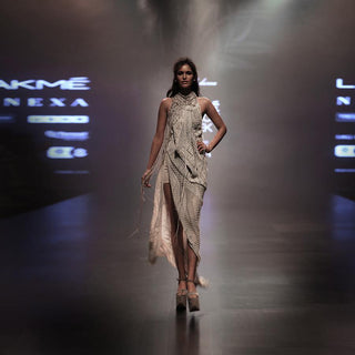 runway view of Women's halter-neck draped gown with asymmetric slit and textural fringe layers for red carpet evenings