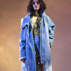 Washed and damaged boyfriend denim jacket with  worn out raw edge hem. Hooded oversized coat is frayed and ripped in abstract patterns around the hem. Mid-length unisex denim coat is embellished with impressionist embroidery appliqué and bugle bead detailing.  abhisheksharma , abhishekstudio