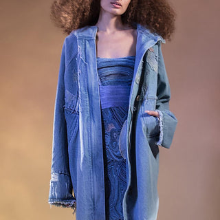 Washed distressed boyfriend denim jacket with playful asymmetrical released raw edge hem. Hooded oversized coat is meticulously frayed and ripped to form an abstract pattern around hem. Mid-length unisex denim coat is embellished with impressionist embroidery appliqué and bugle bead detailing.   abhisheksharma, asbhishestudio