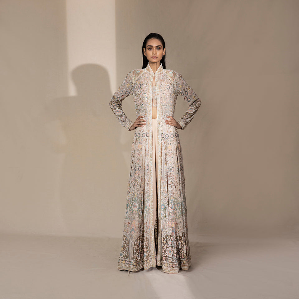fullbody front shot Women's pastel multi-panel flared jacket with intricate floral shadow embroidery – handcrafted bridal outerwear for couture occasions