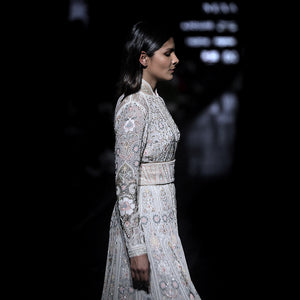 side view of Women's pastel embroidered couture jacket with cinched waist and floral shadow work – runway-ready bridal layer with intricate detailing