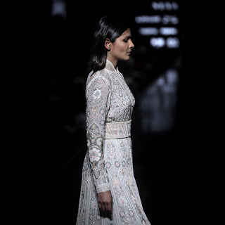 side view of Women's pastel embroidered couture jacket with cinched waist and floral shadow work – runway-ready bridal layer with intricate detailing
