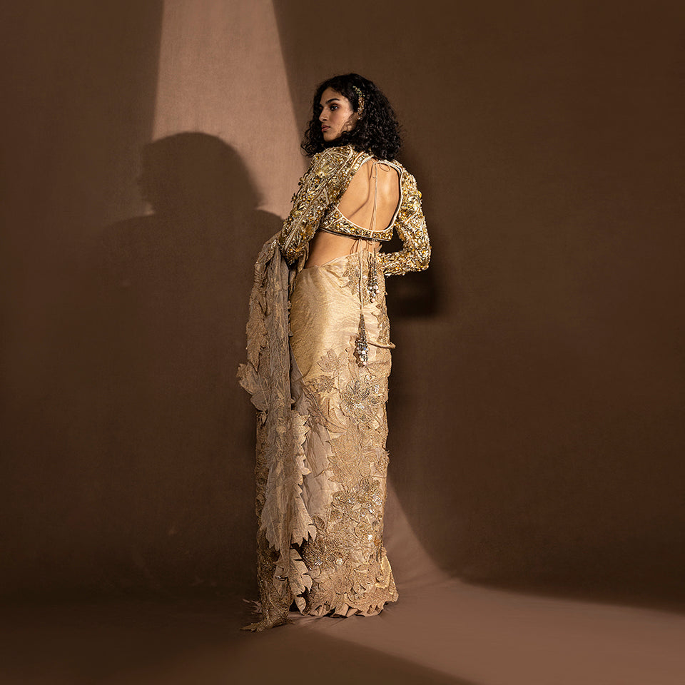 back view of Women's metallic saree with sequin floral detailing and embellished back-tie blouse – pre-pleated draped Chanderi saree with layered leaf motifs, festive couture set