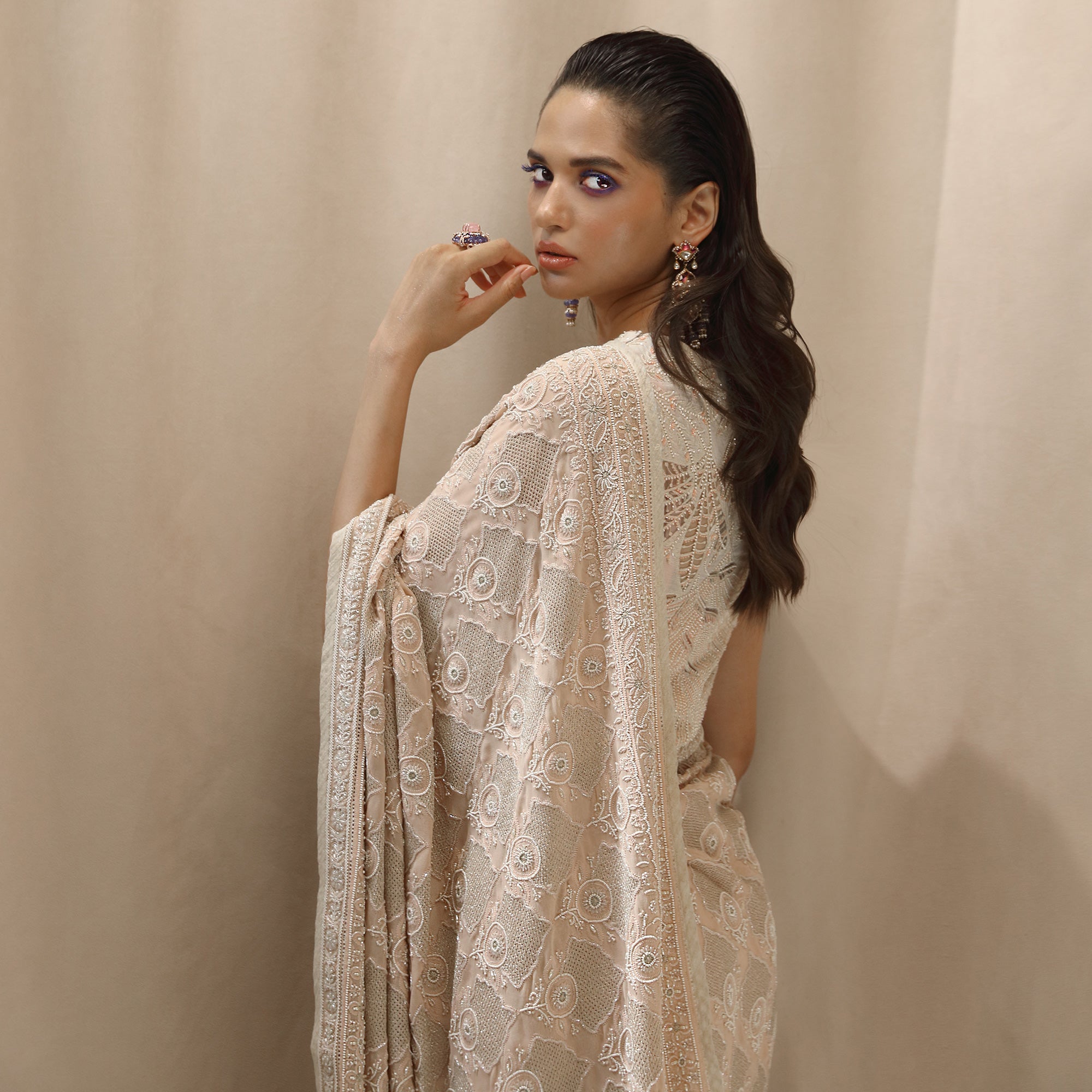 profile shot of Women's pre-draped chikankari saree with circular jaali motifs and ornate border – handcrafted elegance for weddings and traditional functions 