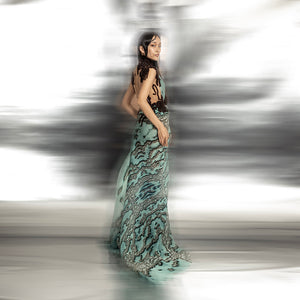 full body side view of Women's reef printed asymmetrical couture gown with open back and artistic drape – textured statement piece for cocktail or red carpet